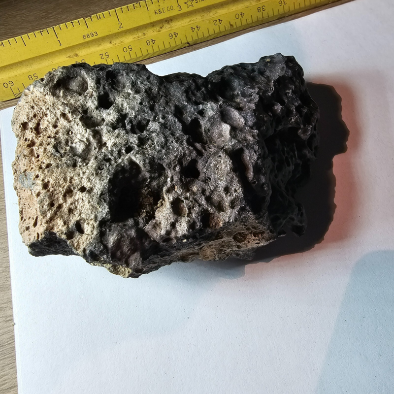 Meteorite rock item is a pitted unknown from Mohave desert 10.75- sample stone.