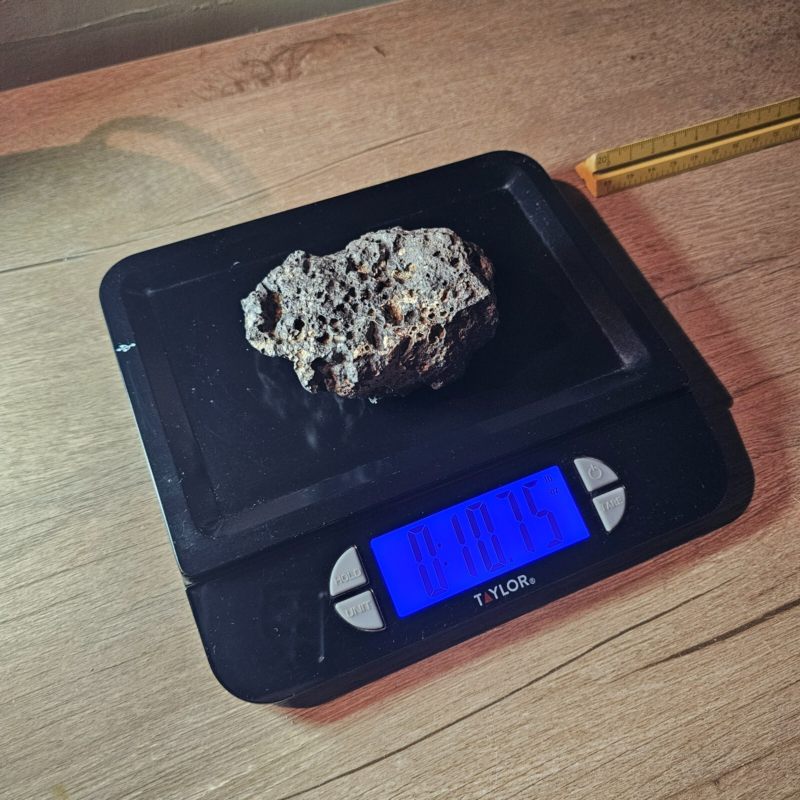 Meteorite rock item is a pitted unknown from Mohave desert 10.75- sample stone.
