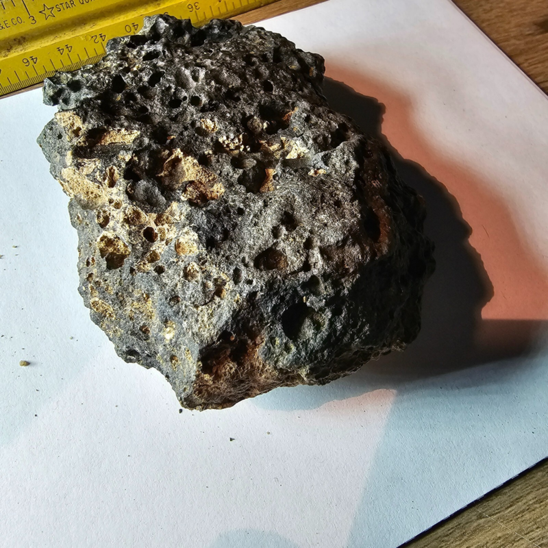 Meteorite rock item is a pitted unknown from Mohave desert 10.75- sample stone.
