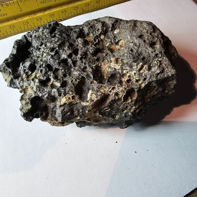 Meteorite rock item is a pitted unknown from Mohave desert 10.75- sample stone.