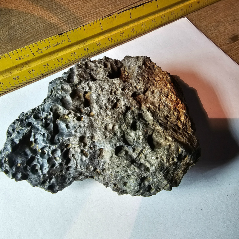 Meteorite rock item is a pitted unknown from Mohave desert 10.75- sample stone.