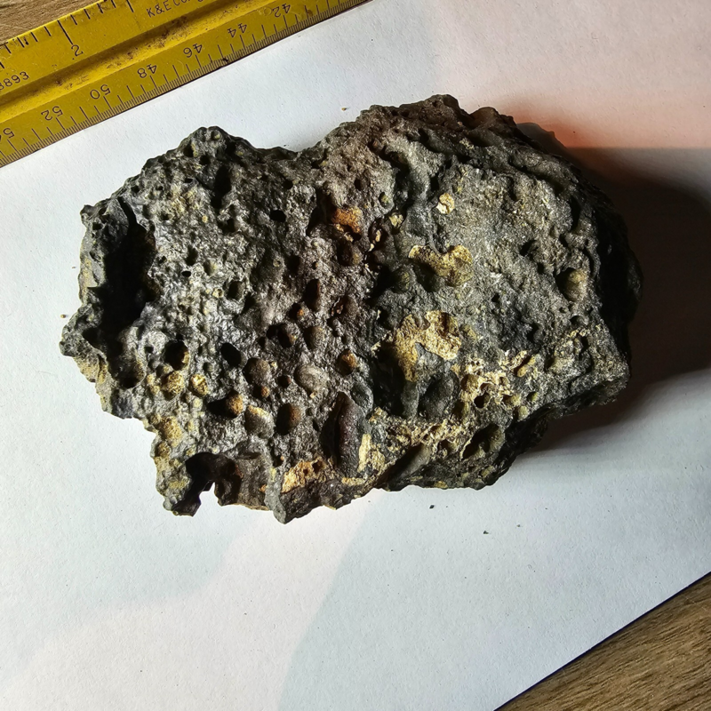 Meteorite rock item is a pitted unknown from Mohave desert 10.75- sample stone.